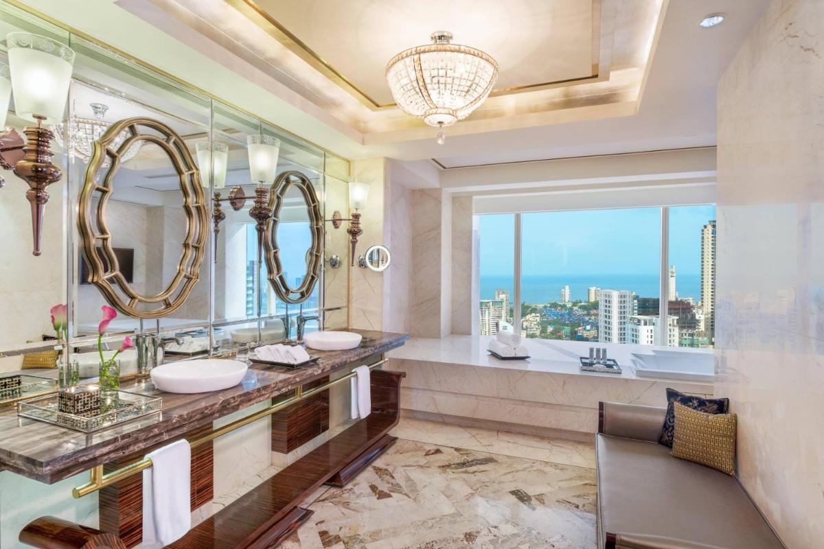 a bathroom with two sinks and a large mirror at The St. Regis Mumbai in Mumbai