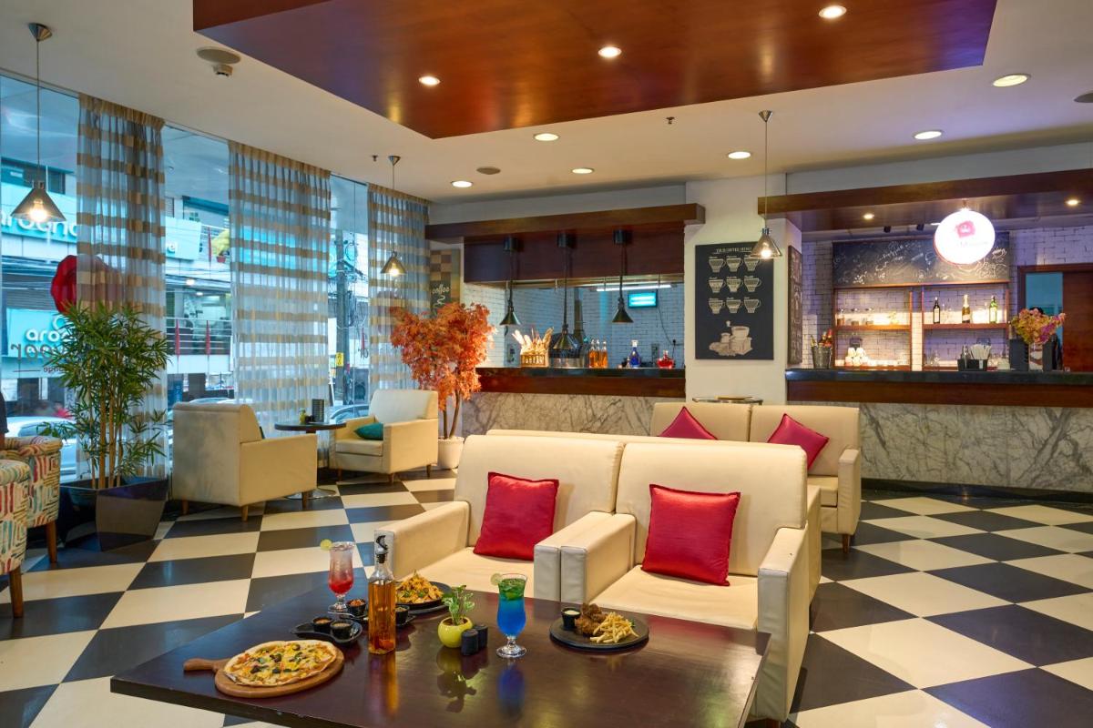 a lobby of a hotel with couches and a bar at The Raviz Calicut in Kozhikode