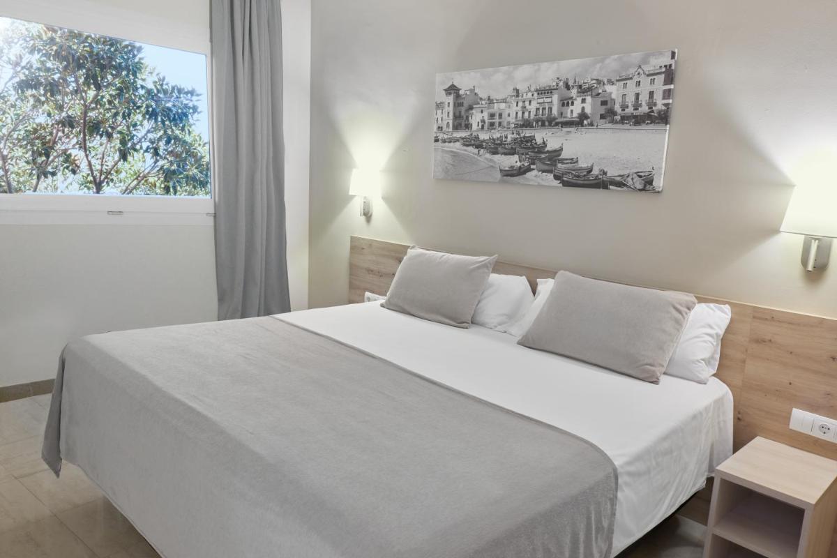 Cama o camas de una habitación en Sunway Playa Golf & Spa Sitges