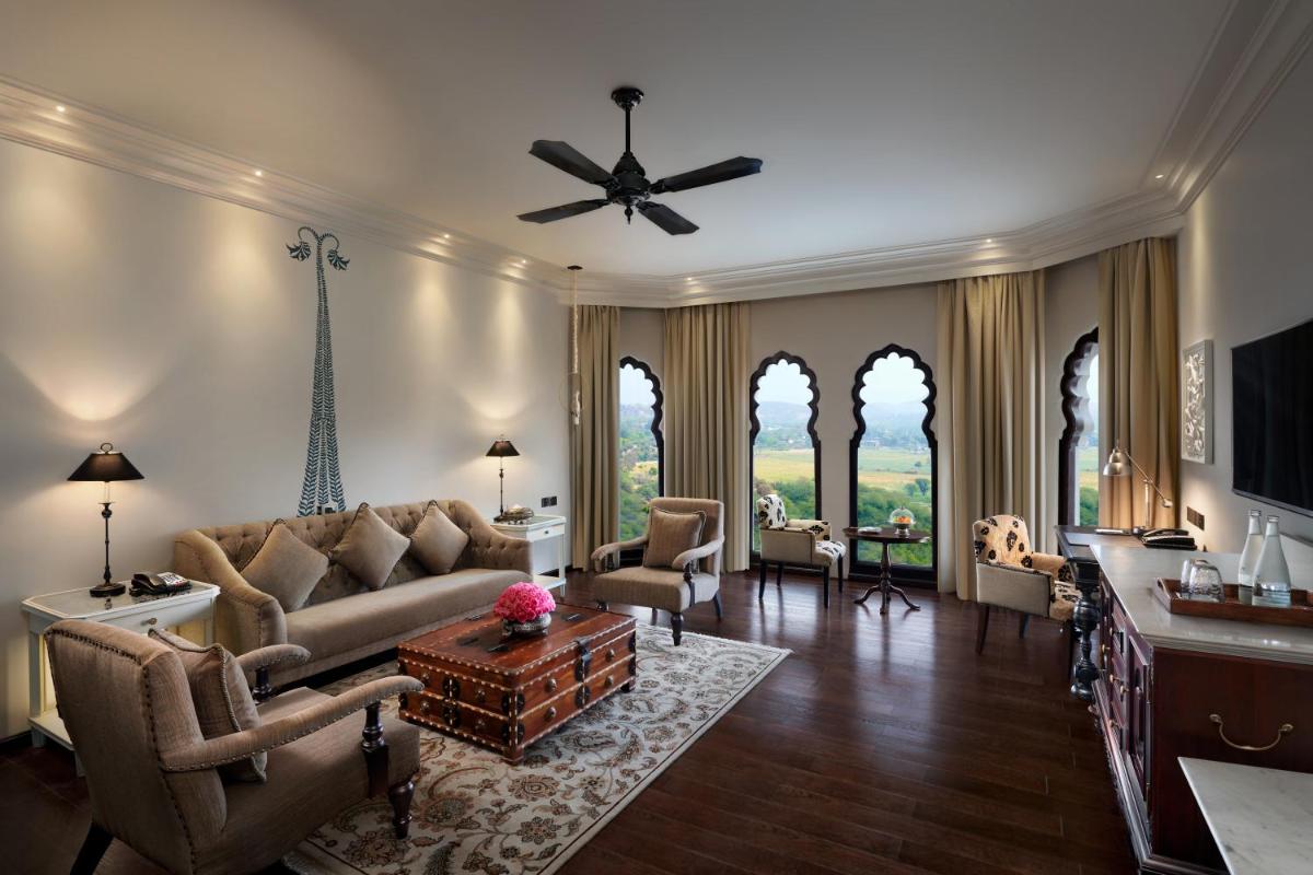 a living room with a couch and a ceiling fan at Fairmont Jaipur in Jaipur