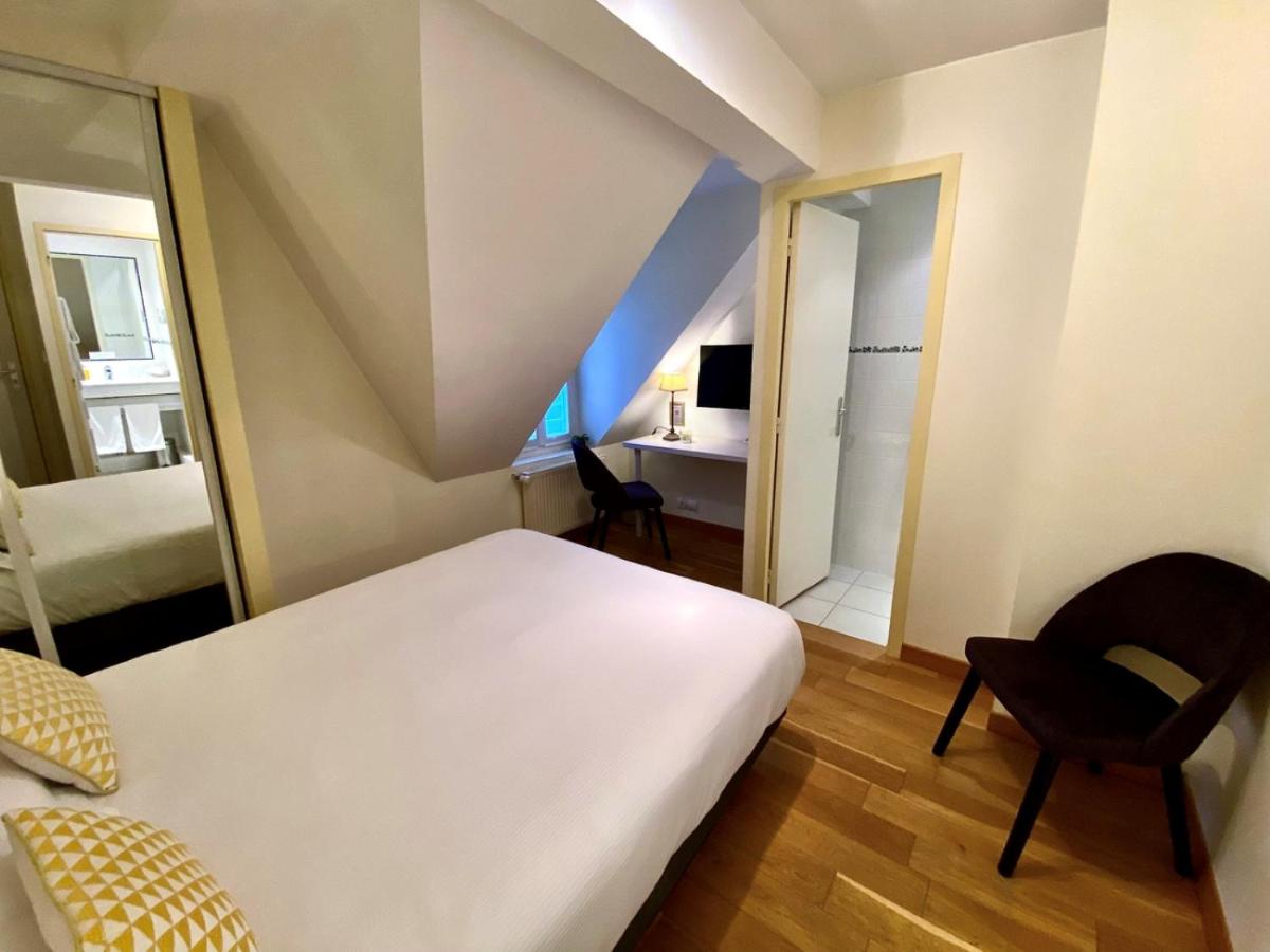 Un ou plusieurs lits dans un hébergement de l'établissement Hôtel Lutétia & Spa