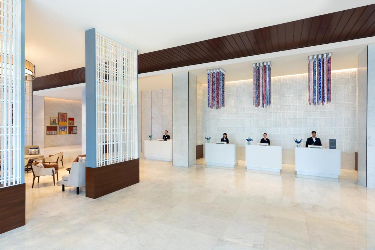 a rendering of a lobby with people sitting at desks at Novotel Jaipur Convention Centre in Jaipur