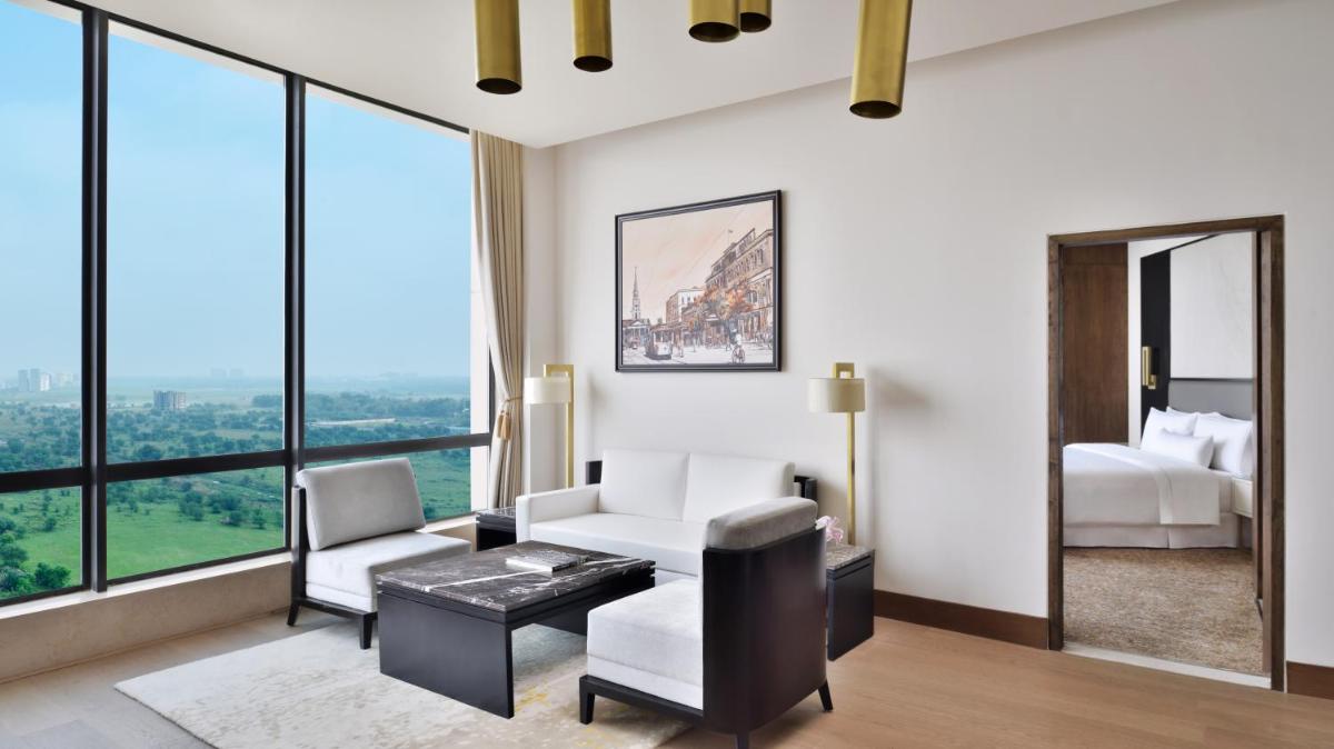 a hotel room with a view of a bedroom at The Westin Kolkata Rajarhat in Kolkata a hotel room with a view of a bedroom at The Westin Kolkata Rajarhat in Kolkata