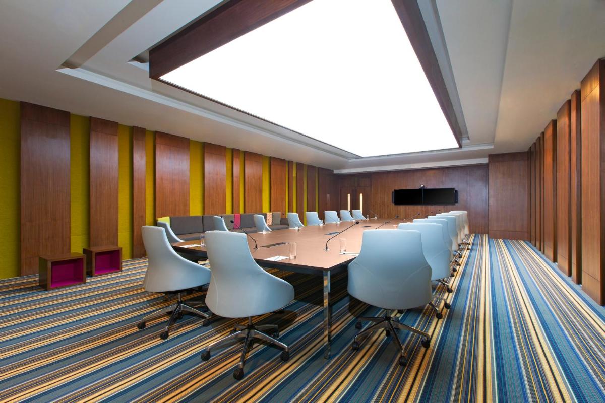a conference room with a long table and chairs at Aloft Bengaluru Outer Ring Road in Bengaluru