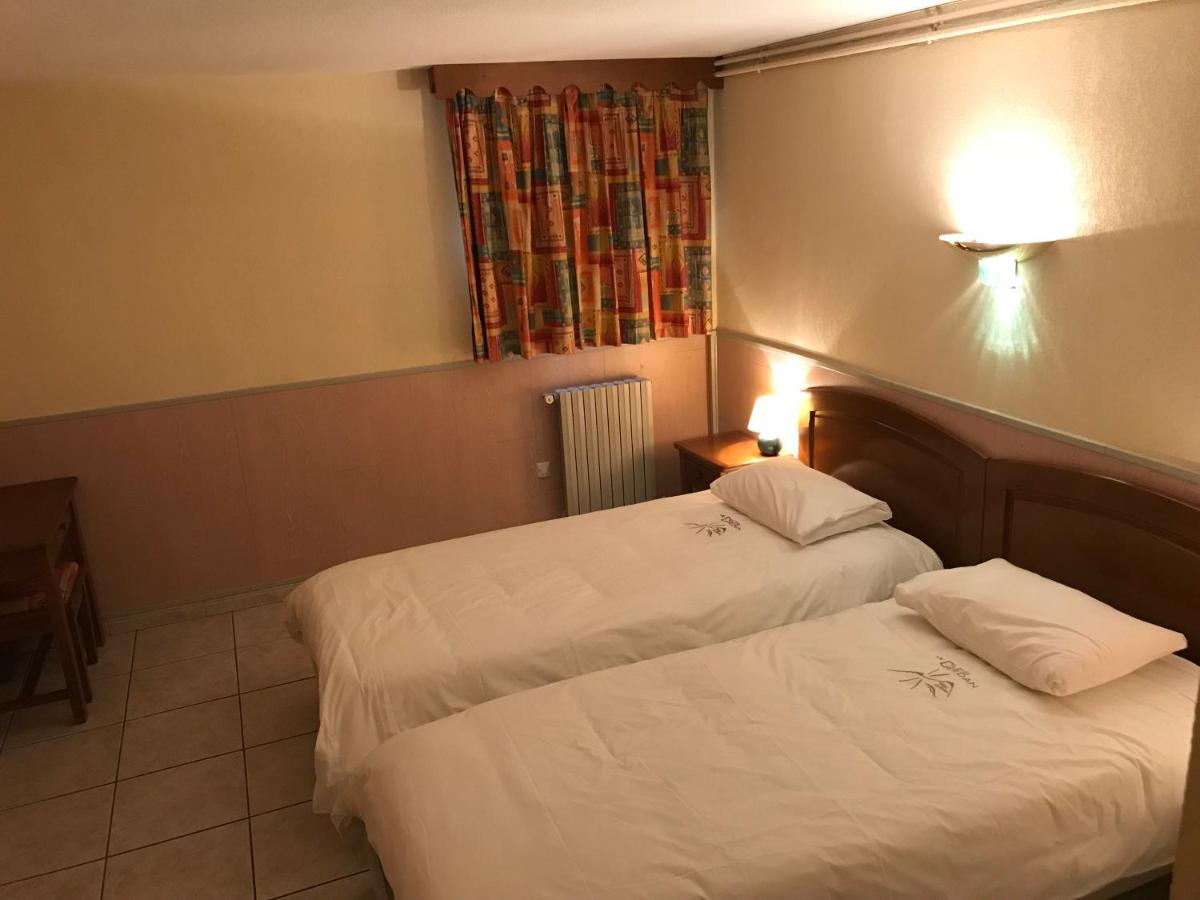 Un ou plusieurs lits dans un hébergement de l'établissement Hotel et Résidence Le Clos Cerdan