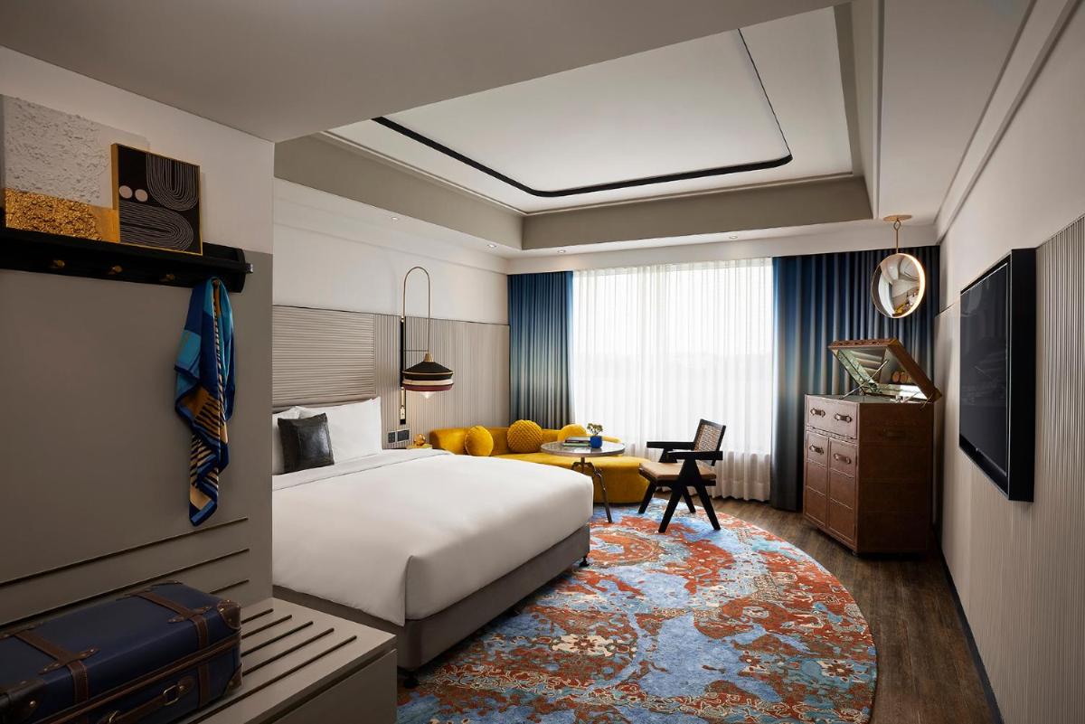 a hotel room with a bed and a desk at Hyatt Centric Sector17 Chandigarh in Chandīgarh