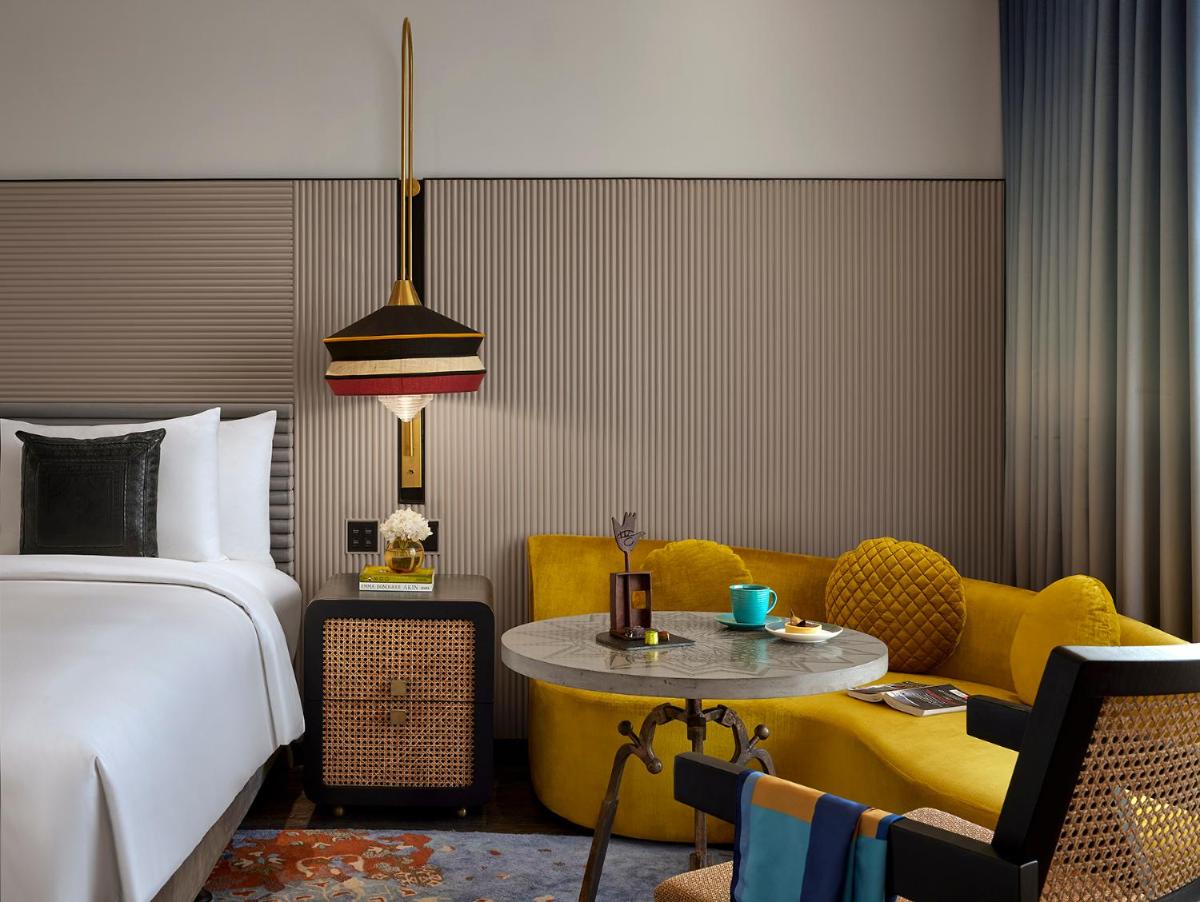 a bedroom with a bed and a couch and a table at Hyatt Centric Sector17 Chandigarh in Chandīgarh