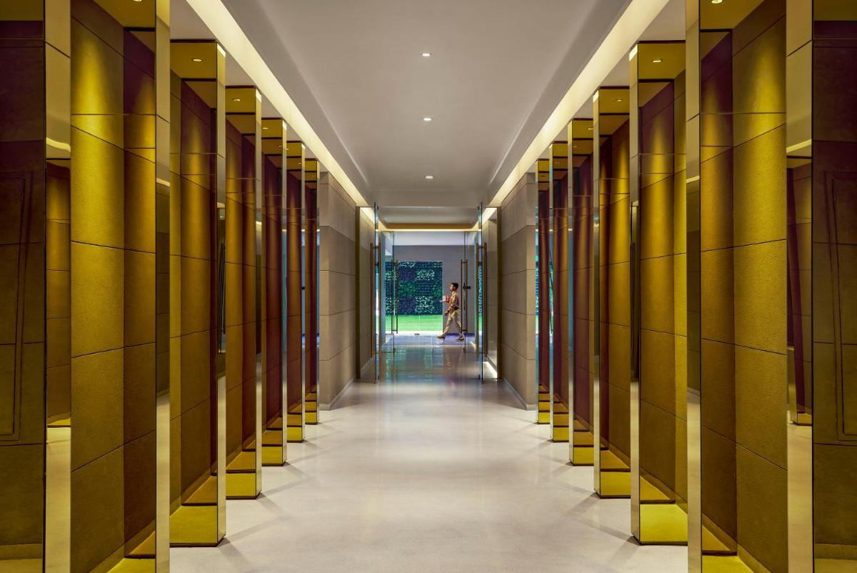 a hallway in a building with yellow columns at Hyatt Centric Sector17 Chandigarh in Chandīgarh