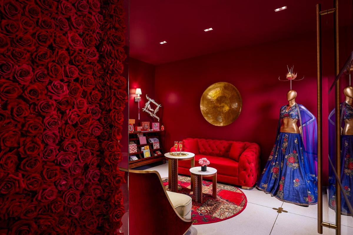 a red living room with a red couch and a table at Hyatt Centric Sector17 Chandigarh in Chandīgarh