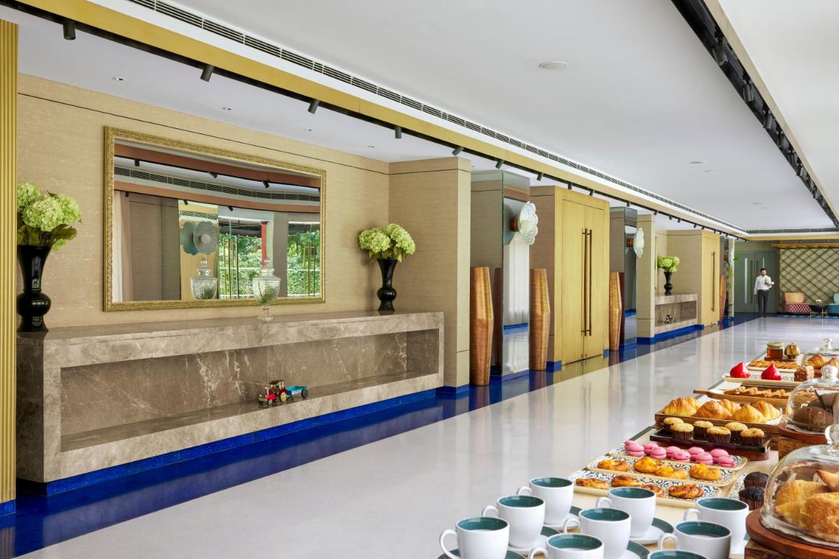a buffet line of food in a hotel cafeteria at Hyatt Centric Sector17 Chandigarh in Chandīgarh