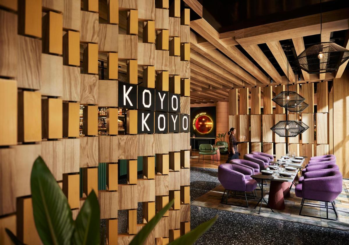 a dining room with purple chairs and a table at Hyatt Centric Sector17 Chandigarh in Chandīgarh