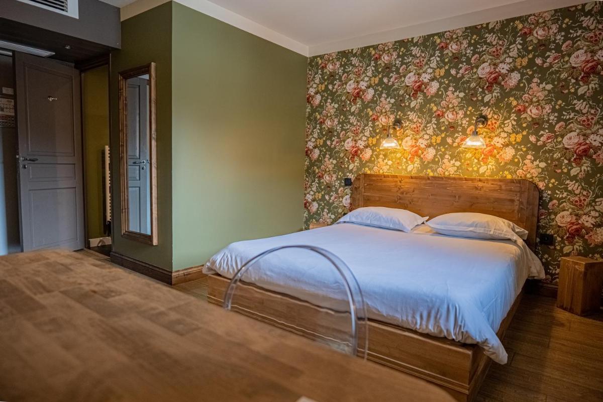 Un ou plusieurs lits dans un hébergement de l'établissement La Maison Rouge