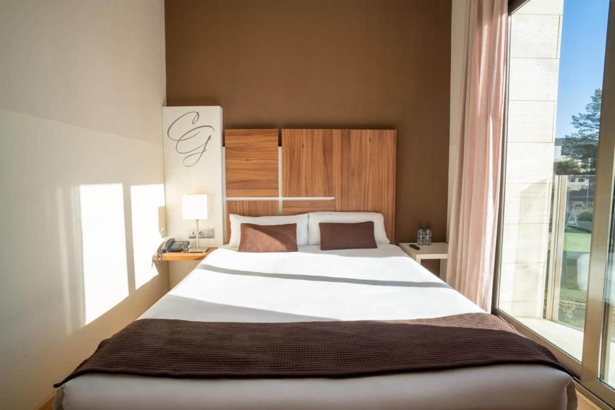 Cama o camas de una habitación en Hotel & Spa Golden Barcelona
