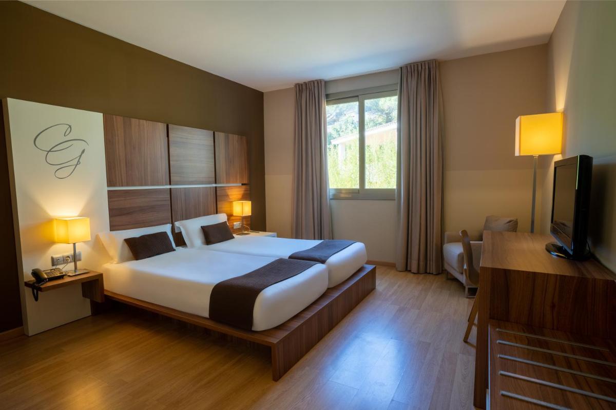 Cama o camas de una habitación en Hotel & Spa Golden Barcelona