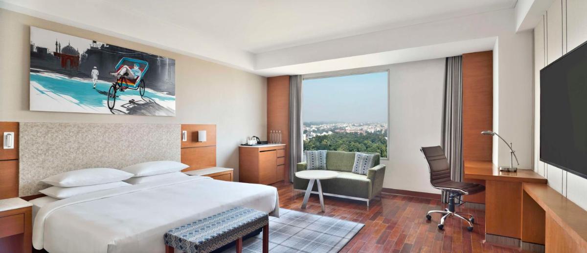 a hotel room with a large bed and a window at Hyatt Centric Janakpuri New Delhi in New Delhi