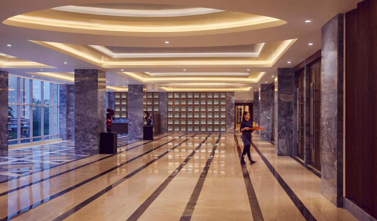 a man standing in a hallway in a building at Hyatt Centric Janakpuri New Delhi in New Delhi