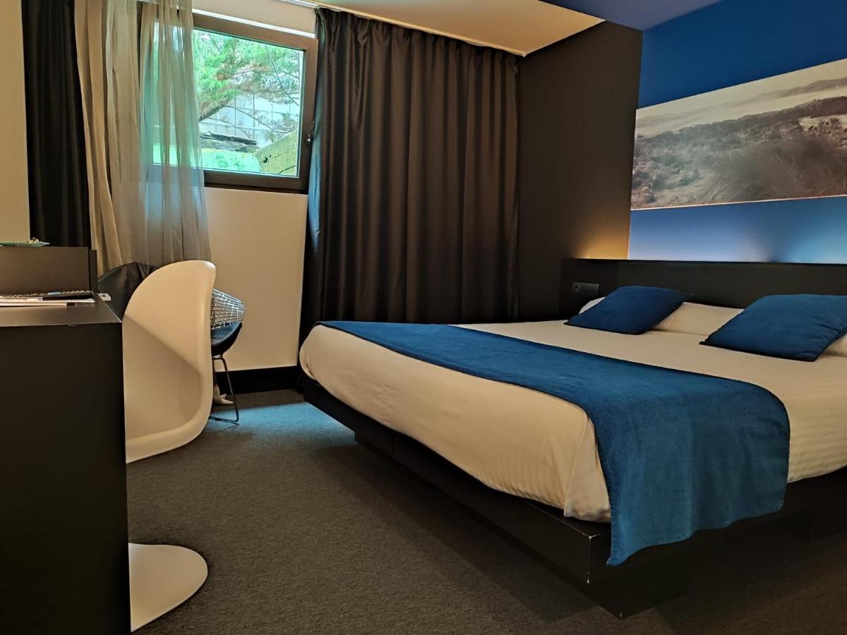 Cama o camas de una habitación en Hotel Playa Ribera