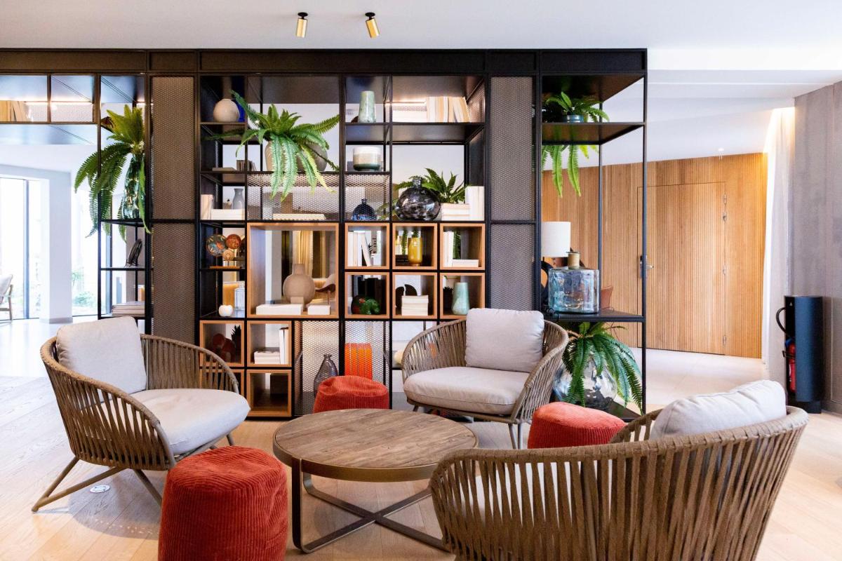 un salon avec des chaises et une table dans l'établissement Paxton Paris MLV, à Ferrières-en-Brie