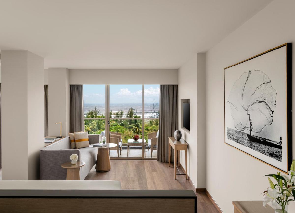 a living room with a view of a living room at Vivanta Goa, Miramar in Panaji a living room with a view of a living room at Vivanta Goa, Miramar in Panaji