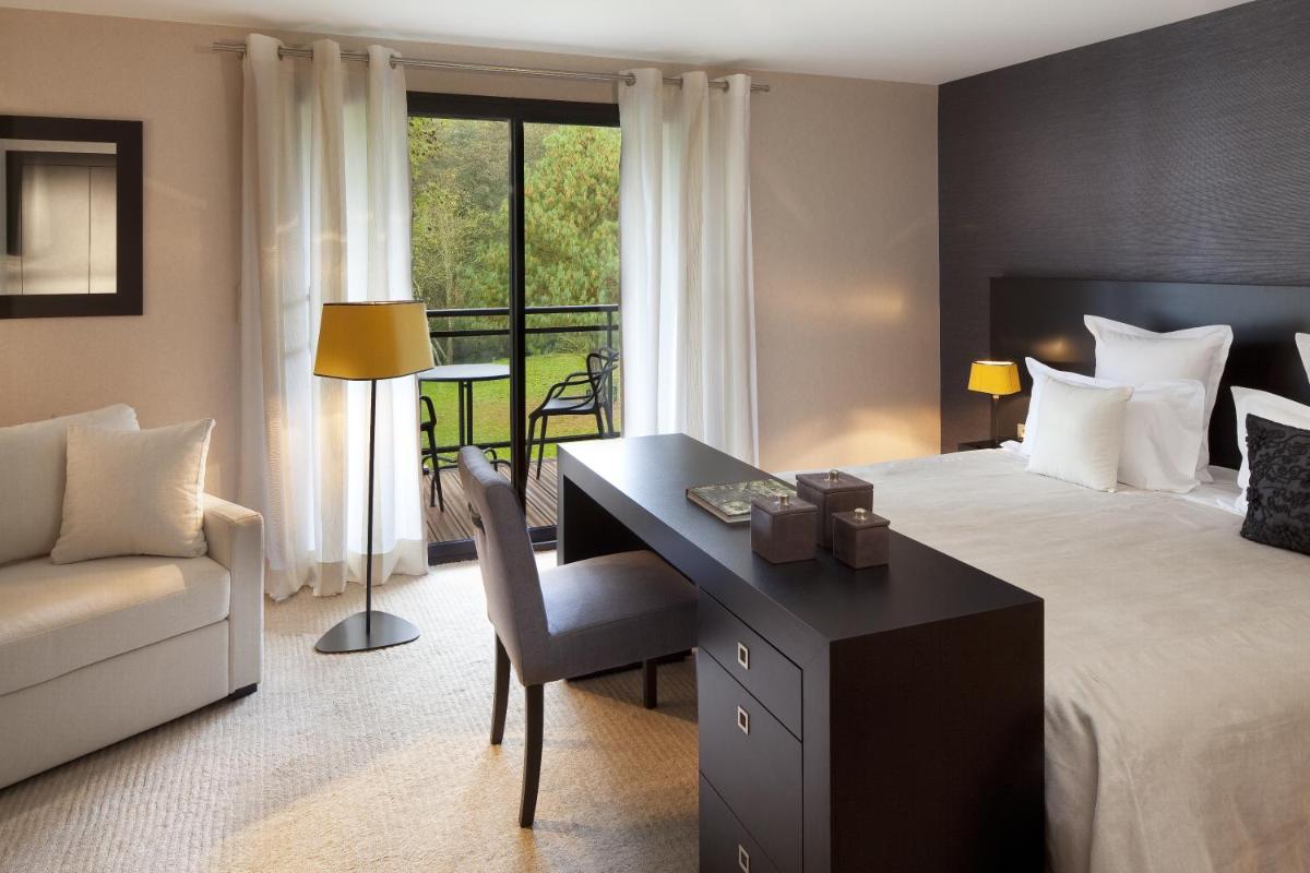 Un ou plusieurs lits dans un hébergement de l'établissement L'Aubinière Hôtel Restaurant & Spa