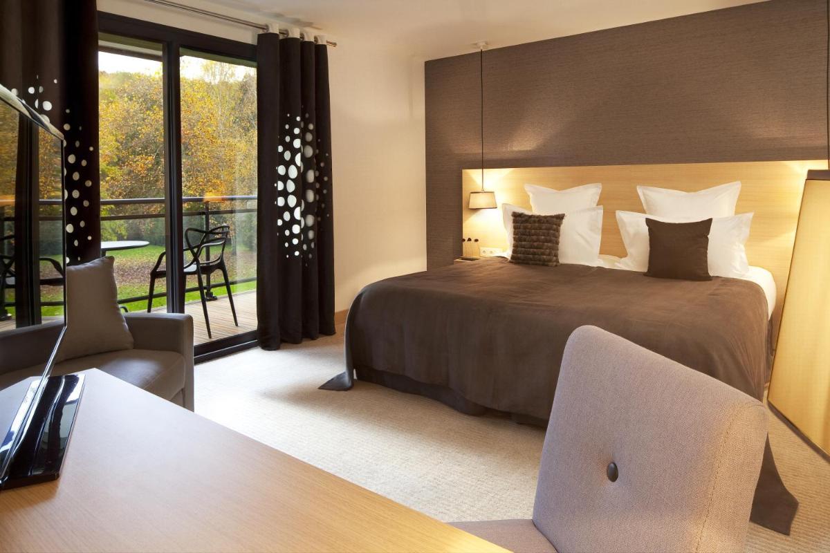 Un ou plusieurs lits dans un hébergement de l'établissement L'Aubinière Hôtel Restaurant & Spa