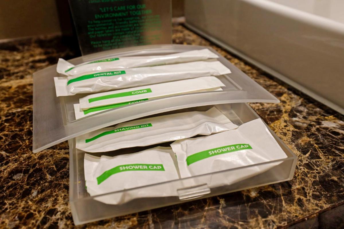 three packages of toilet paper sitting on a counter at Holiday Inn Chennai OMR IT Expressway by IHG in Chennai
