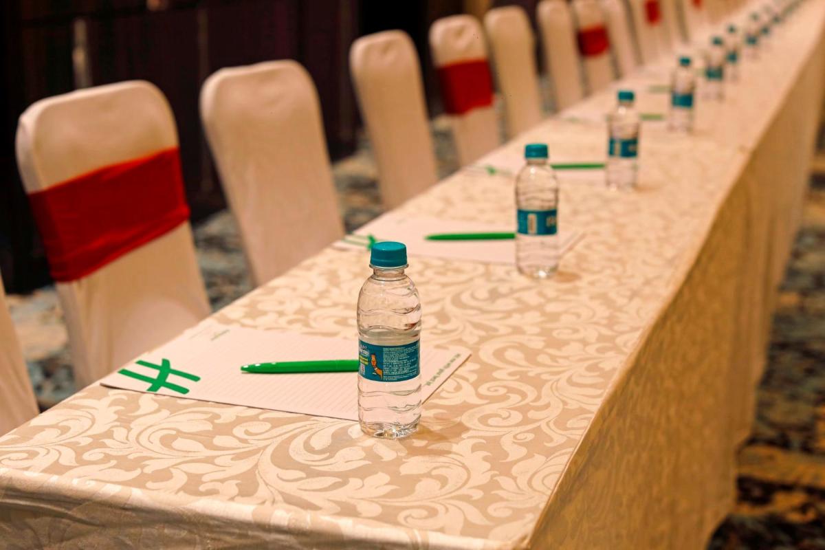 a long table with bottles of water on it at Holiday Inn Chennai OMR IT Expressway by IHG in Chennai