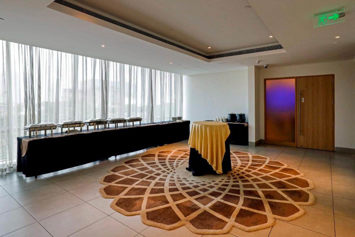a conference room with a table and chairs in it at Holiday Inn Chennai OMR IT Expressway by IHG in Chennai