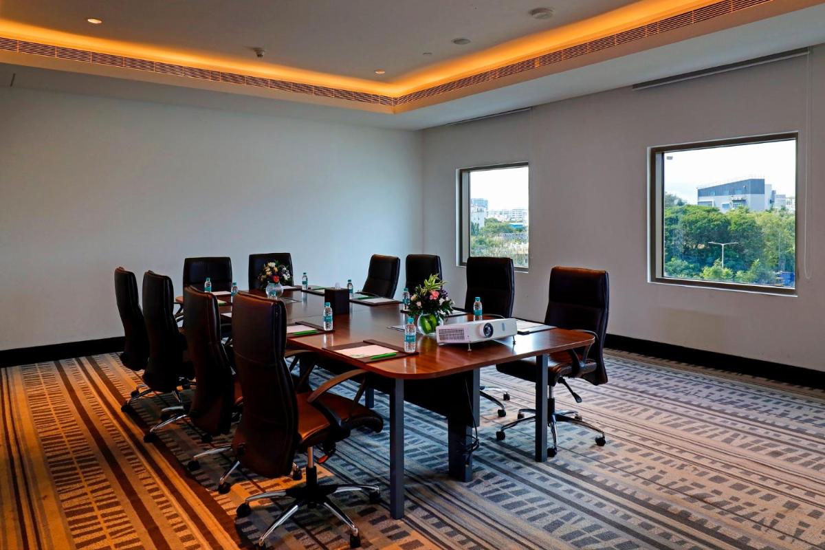a conference room with a long table and chairs at Holiday Inn Chennai OMR IT Expressway by IHG in Chennai