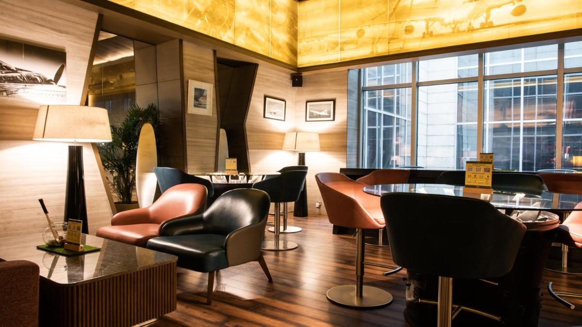 a restaurant with chairs and tables and a large window at Holiday Inn New Delhi Aerocity by IHG in New Delhi