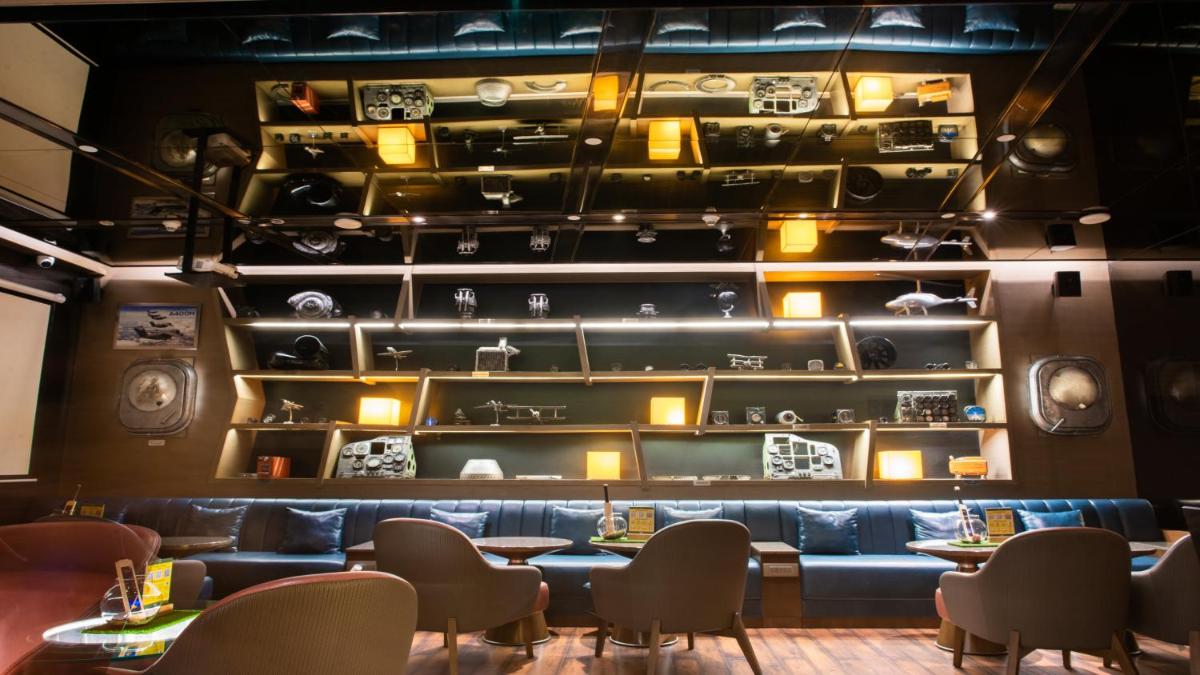 a dining room with tables and chairs and shelves at Holiday Inn New Delhi Aerocity by IHG in New Delhi