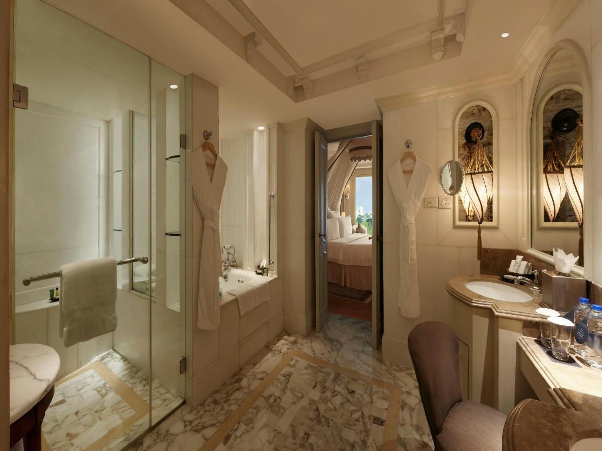 a bathroom with a shower and a sink and a tub at Hilton Mumbai International Airport Hotel in Mumbai