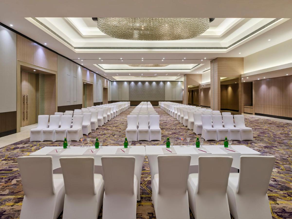 a conference room with white tables and white chairs at Crowne Plaza Ahmedabad City Centre by IHG in Ahmedabad