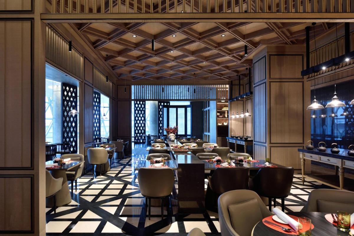 a rendering of a restaurant with tables and chairs at JW Marriott Hotel Kolkata in Kolkata