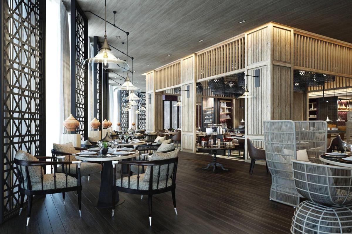 a restaurant with tables and chairs in a room at JW Marriott Hotel Kolkata in Kolkata