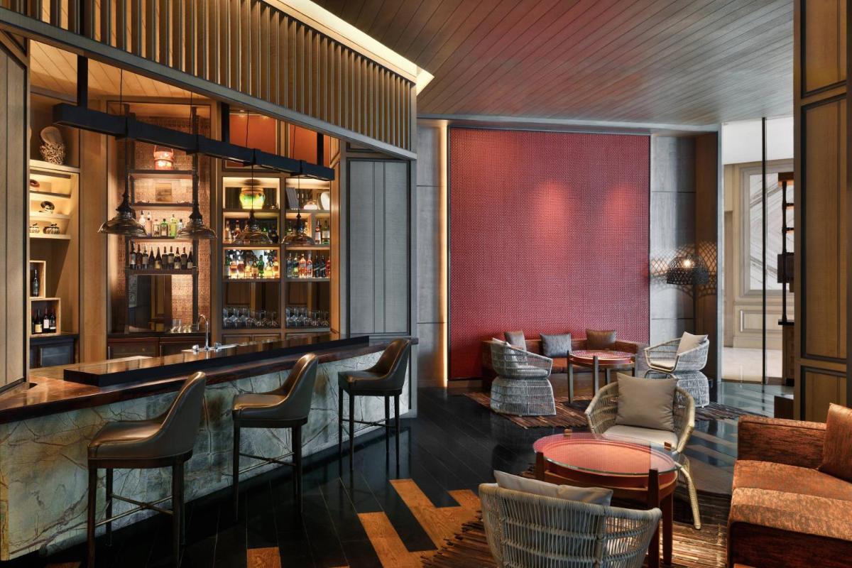 a bar at a restaurant with chairs and tables at JW Marriott Hotel Kolkata in Kolkata