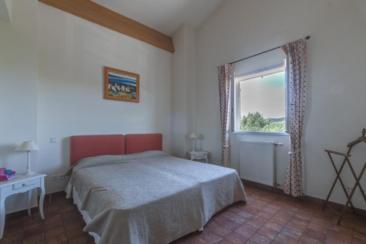 Un ou plusieurs lits dans un hébergement de l'établissement Les Appartements et Maisons du Domaine de Saint Endréol Golf & Spa Resort