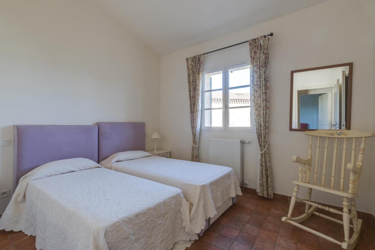 Un ou plusieurs lits dans un hébergement de l'établissement Les Appartements et Maisons du Domaine de Saint Endréol Golf & Spa Resort