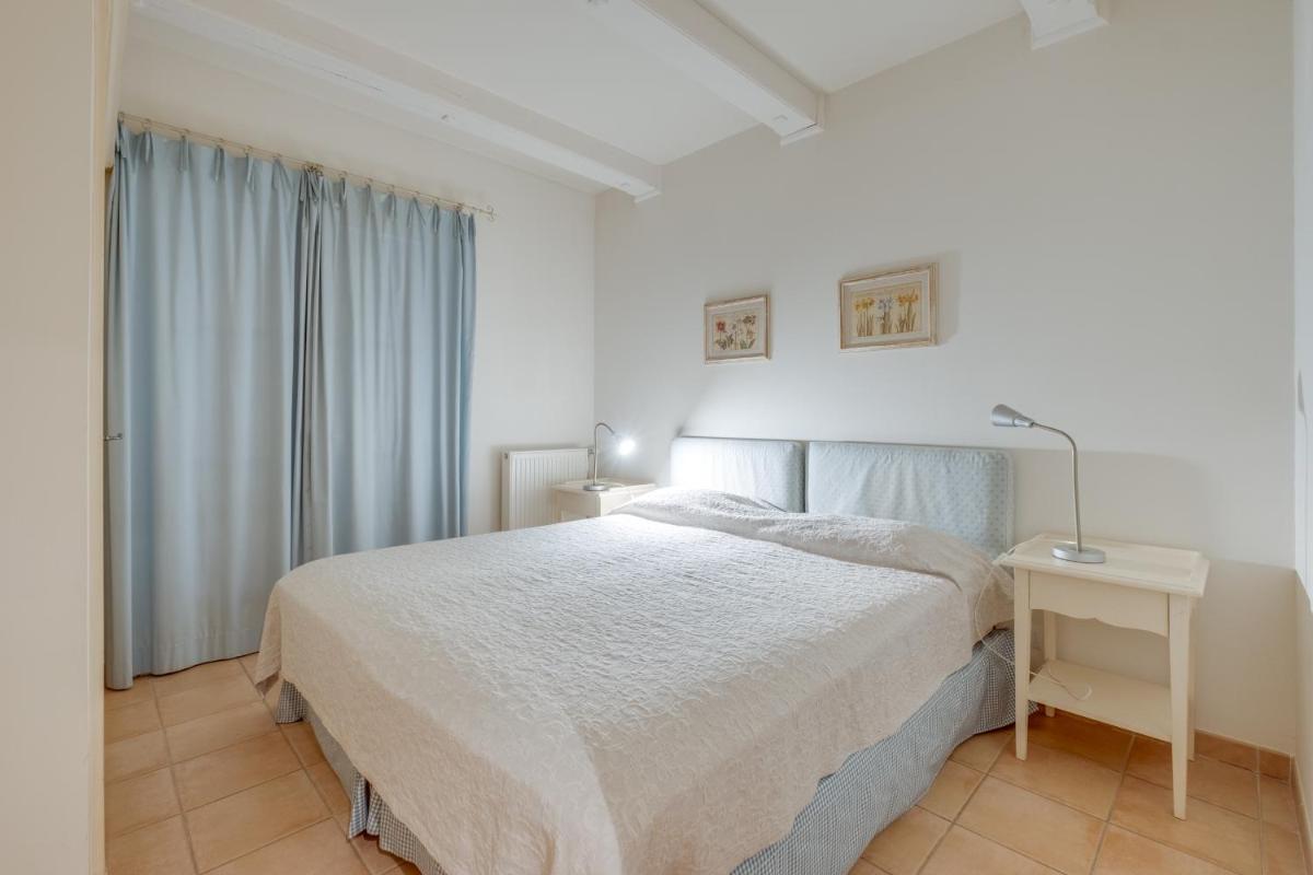 Un ou plusieurs lits dans un hébergement de l'établissement Les Appartements et Maisons du Domaine de Saint Endréol Golf & Spa Resort