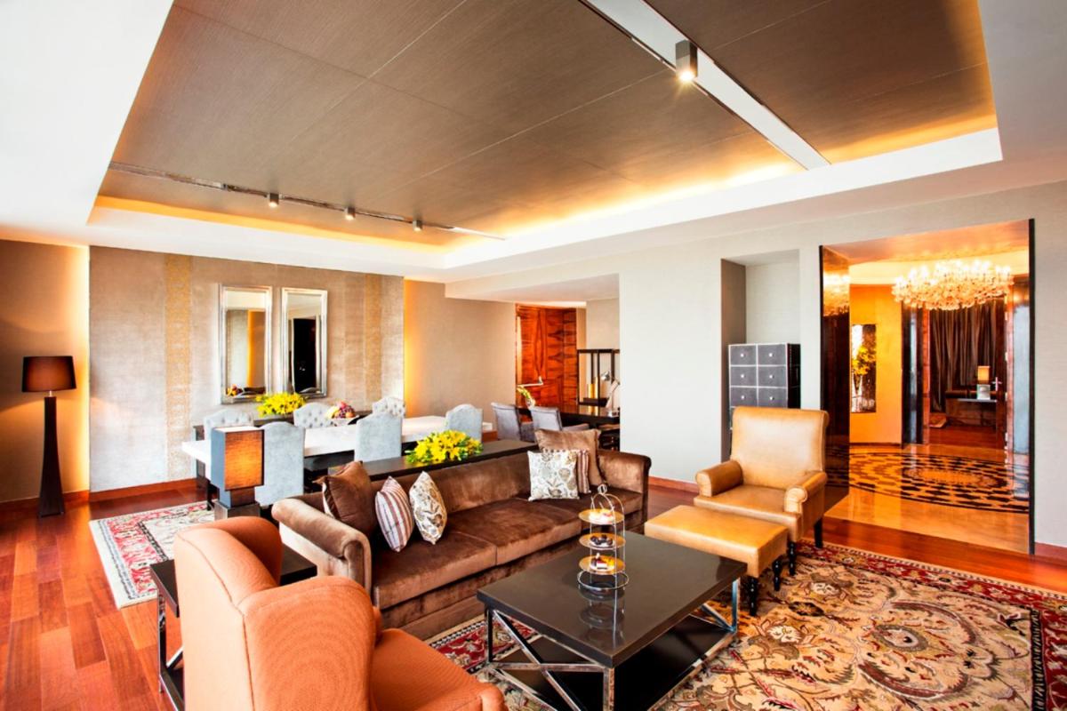 a living room with a couch and a table at Taj City Centre Gurugram in Gurgaon
