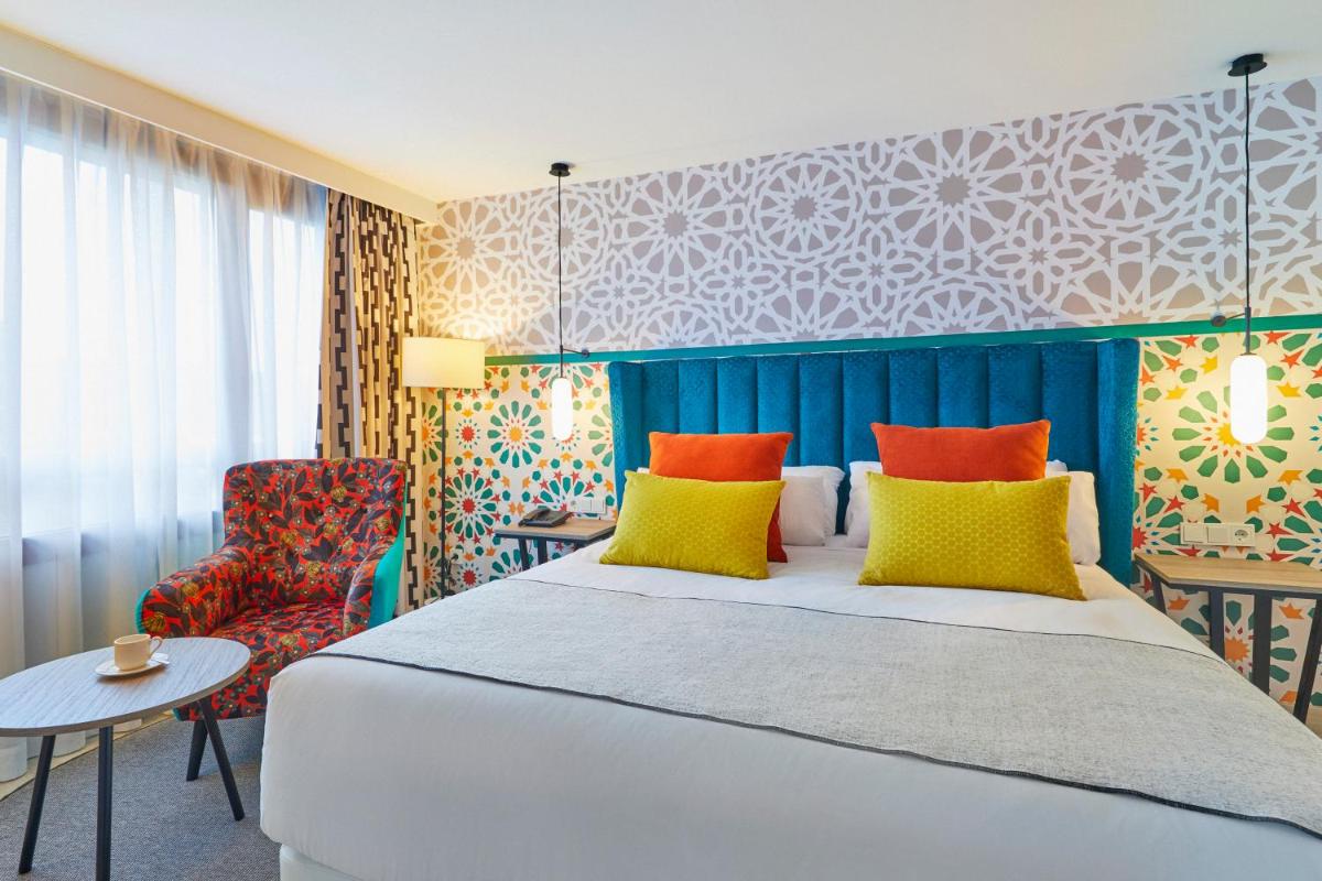 Cama o camas de una habitación en Hesperia Sevilla