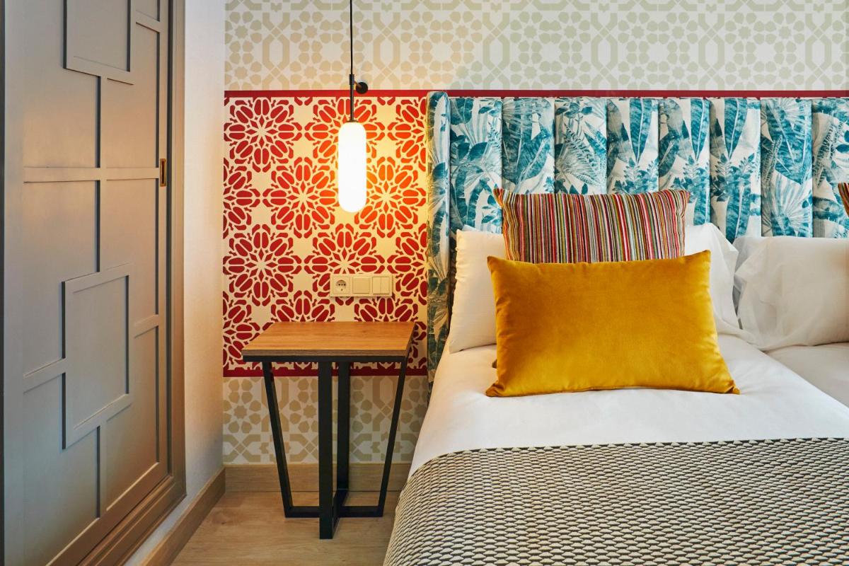Cama o camas de una habitación en Hesperia Sevilla