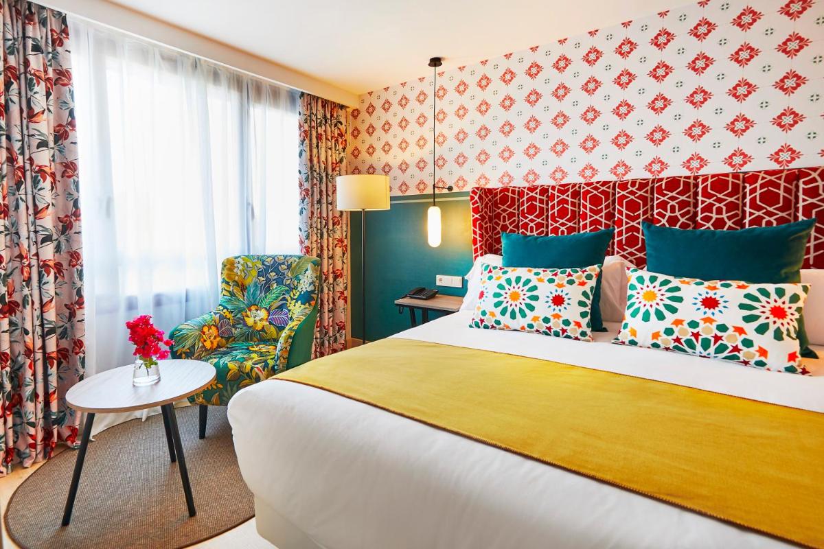 Cama o camas de una habitación en Hesperia Sevilla