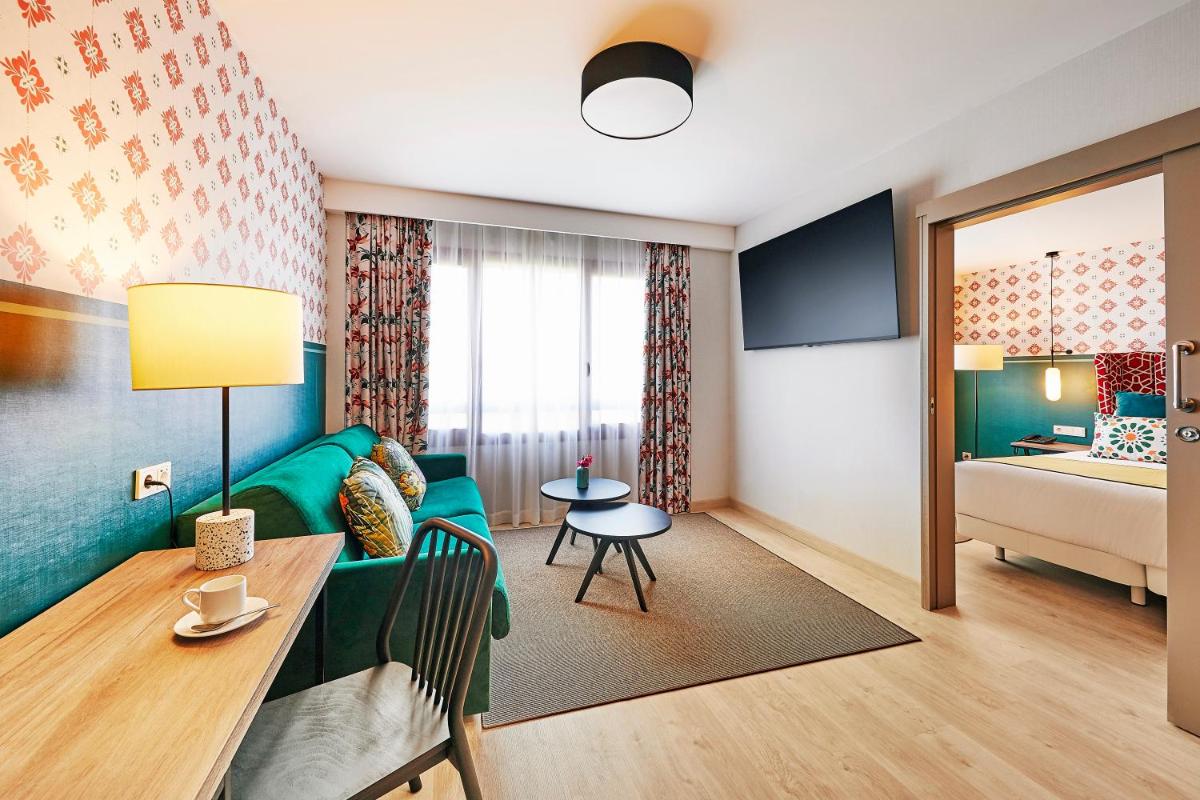 Cama o camas de una habitación en Hesperia Sevilla