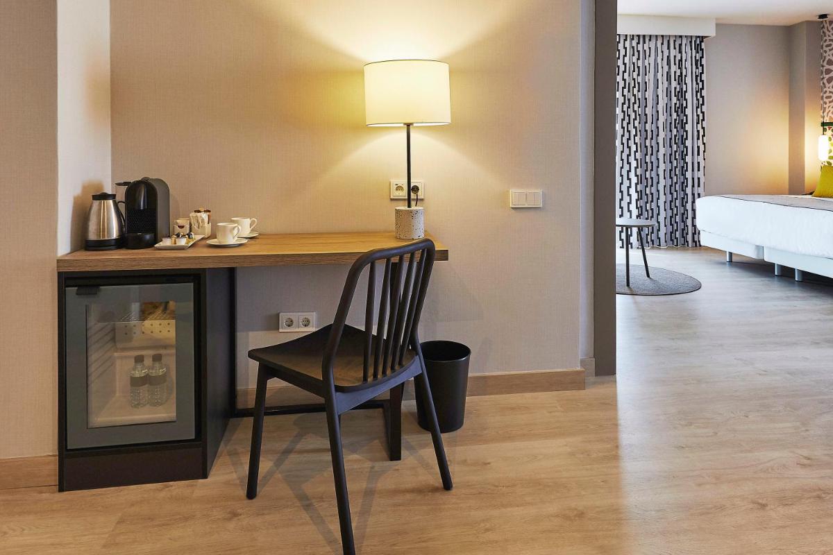 Cama o camas de una habitación en Hesperia Sevilla