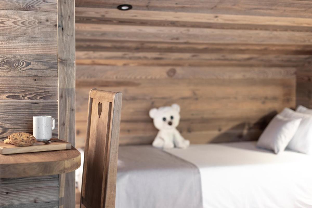 Un ou plusieurs lits dans un hébergement de l'établissement Hôtel et Spa Le Vermont