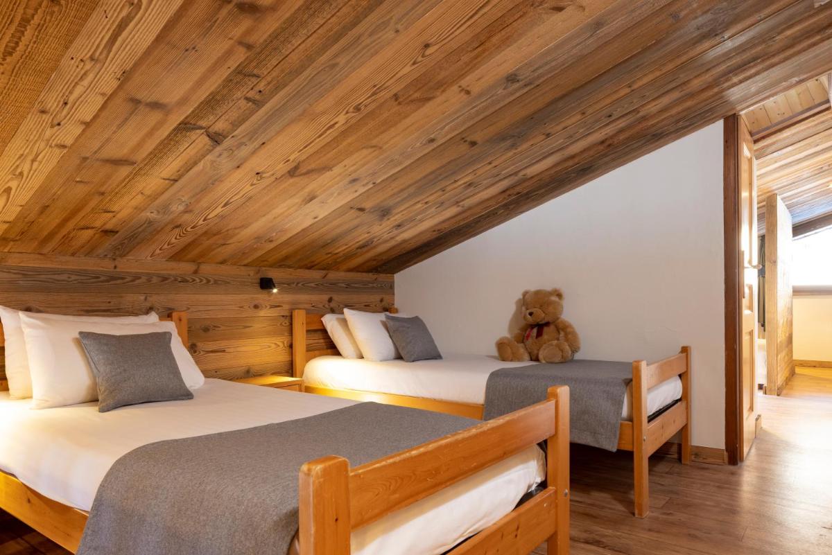 Un ou plusieurs lits dans un hébergement de l'établissement Hôtel et Spa Le Vermont