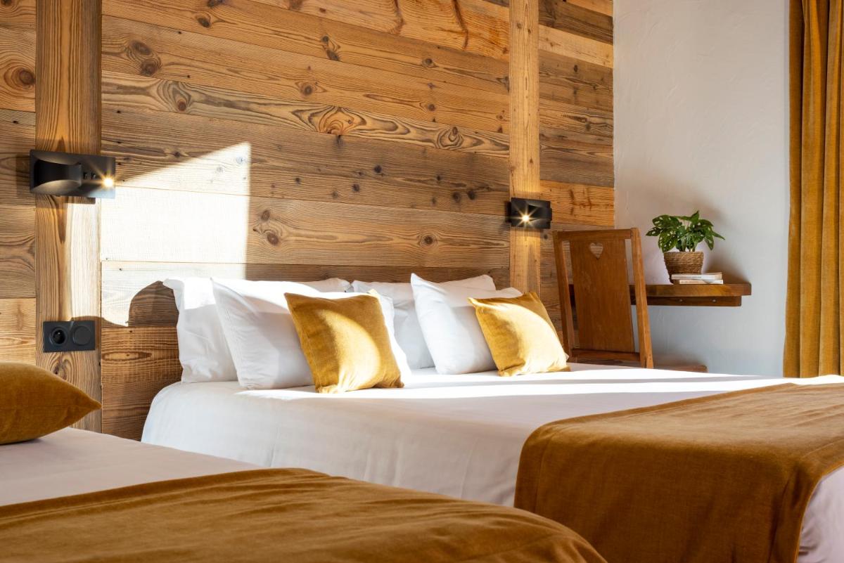 Un ou plusieurs lits dans un hébergement de l'établissement Hôtel et Spa Le Vermont