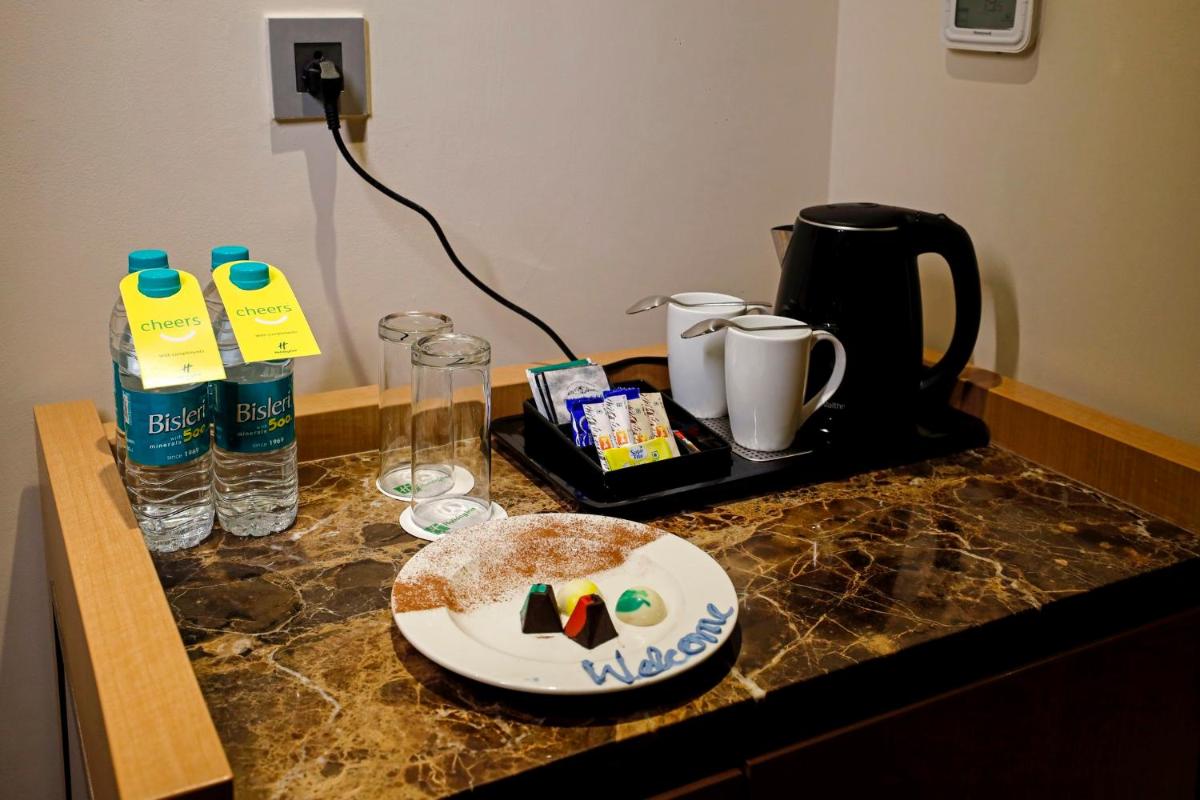 a table with a plate of cake on a counter at Holiday Inn Chennai OMR IT Expressway by IHG in Chennai