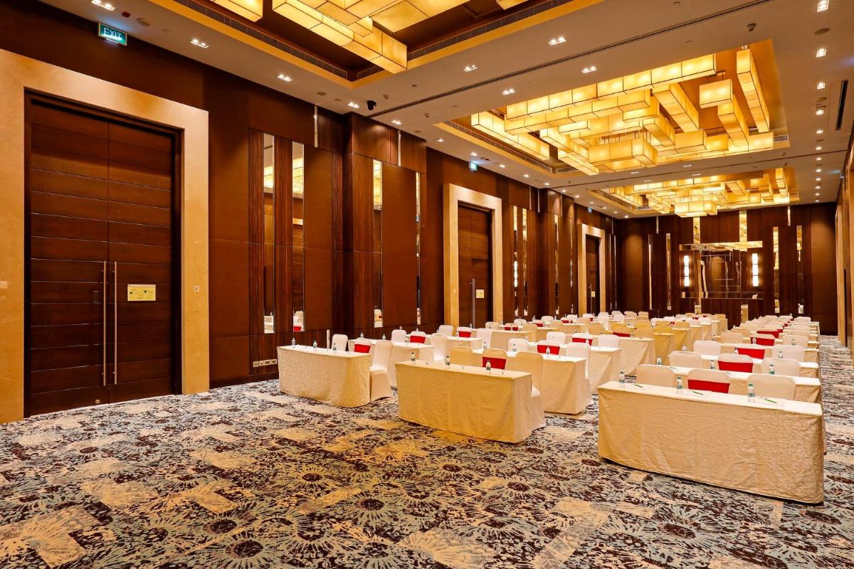 a conference room with white tables and chairs at Holiday Inn Chennai OMR IT Expressway by IHG in Chennai